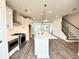 Open kitchen with island, stainless steel appliances, and view to the living room at 500 Healy Dr # 77, Cumming, GA 30040