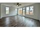 Living room featuring hardwood floors, ceiling fan, and ample natural light at 500 Healy Dr # 77, Cumming, GA 30040