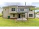 Back of two story house featuring deck and patio area overlooking the yard at 6118 Arbor Links Rd, Lithonia, GA 30058