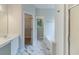 Bright bathroom featuring marble-look tile flooring, bathtub and a walk-in closet at 6118 Arbor Links Rd, Lithonia, GA 30058