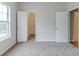 Carpeted bedroom with a window, closet, and entrances to the rest of the house at 6118 Arbor Links Rd, Lithonia, GA 30058