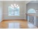 Hardwood dining room with chandelier lighting and large windows, ready for entertaining at 6118 Arbor Links Rd, Lithonia, GA 30058