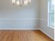 Dining room features a chandelier, chair railing, and beautiful hardwood floors at 6118 Arbor Links Rd, Lithonia, GA 30058