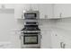 Close up of the new stainless steel oven and microwave and ample white countertop space at 6118 Arbor Links Rd, Lithonia, GA 30058