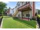 Exterior backyard featuring a lush lawn and a brick patio with access to an elevated deck at 1560 Heritage Trl, Roswell, GA 30075