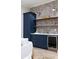 This bar area is fully equipped with custom cabinetry, shelving, and a beverage refrigerator at 1560 Heritage Trl, Roswell, GA 30075