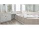 Large bathroom with soaking tub, vanity, and updated finishes at 1560 Heritage Trl, Roswell, GA 30075