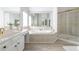 Bright bathroom featuring a soaking tub, shower, and vanity at 1560 Heritage Trl, Roswell, GA 30075