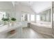 Beautiful bathroom featuring a soaking tub, a vanity, and mirrors at 1560 Heritage Trl, Roswell, GA 30075