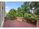 Spacious wooden deck surrounded by lush green trees, perfect for outdoor relaxation at 1560 Heritage Trl, Roswell, GA 30075
