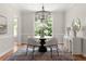 Dining room with hardwood floors, round table with modern chairs, and natural light at 1560 Heritage Trl, Roswell, GA 30075
