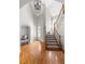 Grand foyer with hardwood floors, a staircase, and soaring ceilings with modern light fixture at 1560 Heritage Trl, Roswell, GA 30075