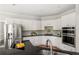 Bright kitchen featuring white cabinetry, stainless steel appliances and bar seating area at 1560 Heritage Trl, Roswell, GA 30075