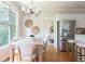 A bright kitchen with stainless steel refrigerator, adjacent dining area and hardwood floors at 1560 Heritage Trl, Roswell, GA 30075