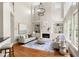 Bright living room with soaring ceilings, large windows, fireplace, and comfortable seating area at 1560 Heritage Trl, Roswell, GA 30075