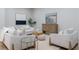 The open concept living room has neutral paint, a small plant, and stylish furniture at 1560 Heritage Trl, Roswell, GA 30075