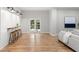 This spacious living area is enhanced by a bar area, wood floors, and a view of the backyard at 1560 Heritage Trl, Roswell, GA 30075
