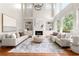 Bright and airy living room with large windows, fireplace, comfortable seating, and hardwood floors at 1560 Heritage Trl, Roswell, GA 30075