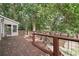 Large wooden deck offering a serene outdoor space, with views of the surrounding greenery and wooded area at 3657 Linda Dr, Loganville, GA 30052