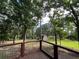 Wood deck overlooks a verdant backyard, featuring a charming shed and ample space for outdoor activities at 3657 Linda Dr, Loganville, GA 30052