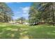 Expansive backyard featuring lush green grass and a serene lake view, perfect for outdoor relaxation and recreation at 3657 Linda Dr, Loganville, GA 30052