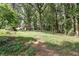 Spacious backyard with mature trees, offering privacy and a peaceful environment, perfect for enjoying the outdoors at 3657 Linda Dr, Loganville, GA 30052