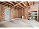 Unfinished basement space with exposed brick, insulation, and storage shelves, ready for your custom design at 3657 Linda Dr, Loganville, GA 30052