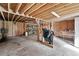 Unfinished basement space with shelving, wooden beams, and concrete floors, ready for customization and storage at 3657 Linda Dr, Loganville, GA 30052