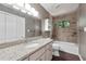 Bathroom with granite countertops, white cabinets, and tiled shower and tub at 3657 Linda Dr, Loganville, GA 30052