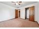 Bedroom with neutral carpet, ceiling fan, and closet at 3657 Linda Dr, Loganville, GA 30052