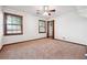 Bedroom with neutral carpet, two large windows, and a ceiling fan at 3657 Linda Dr, Loganville, GA 30052