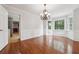 Bright dining room with bay window, hardwood floors, and elegant chandelier at 3657 Linda Dr, Loganville, GA 30052