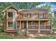 Charming two-story brick home with a welcoming front porch and well-maintained landscaping at 3657 Linda Dr, Loganville, GA 30052