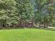 Charming house nestled among mature trees with a well-manicured front lawn, offering a peaceful and private setting at 3657 Linda Dr, Loganville, GA 30052