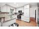 Classic white kitchen with granite counters, ample cabinetry, and stainless steel appliances at 3657 Linda Dr, Loganville, GA 30052