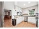 Open kitchen with granite countertops, stainless appliances, and wood floors at 3657 Linda Dr, Loganville, GA 30052