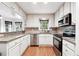 Well-lit kitchen featuring granite counters, stainless steel appliances, and white cabinetry at 3657 Linda Dr, Loganville, GA 30052