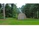 Exterior of a backyard shed surrounded by lush green trees at 3657 Linda Dr, Loganville, GA 30052