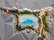 Aerial view of community pool surrounded by sun loungers, umbrellas, well-manicured landscaping, and residential buildings at 800 Peachtree Ne St # 8612, Atlanta, GA 30308