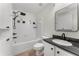 Well-lit bathroom featuring white tiling, granite vanity, and modern fixtures at 800 Peachtree Ne St # 8612, Atlanta, GA 30308