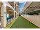 Outdoor dog run with artificial turf, waste station and adjacent covered parking for convenient access at 800 Peachtree Ne St # 8612, Atlanta, GA 30308