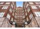Brick apartment building exterior with bright windows and stone work at the entry points in an upward gazing perspective at 800 Peachtree Ne St # 8612, Atlanta, GA 30308