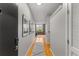 Hallway with hardwood floors and gray walls featuring modern decor and leading to the living space at 800 Peachtree Ne St # 8612, Atlanta, GA 30308