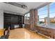 Living area with built-in shelves and exposed brick walls with large windows providing ample natural light at 800 Peachtree Ne St # 8612, Atlanta, GA 30308