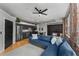 Open concept living space featuring an exposed brick wall, modern kitchen, and comfortable blue couch at 800 Peachtree Ne St # 8612, Atlanta, GA 30308
