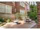 Charming outdoor patio with brick paving, cozy seating, and lush landscaping, perfect for relaxation and entertaining at 800 Peachtree Ne St # 8612, Atlanta, GA 30308