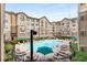 Community pool and lounging area with umbrellas and landscaping for apartment residents to enjoy at 800 Peachtree Ne St # 8612, Atlanta, GA 30308