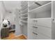 Spacious walk-in closet featuring built-in shelving and drawers, conveniently located near the bedroom at 800 Peachtree Ne St # 8612, Atlanta, GA 30308