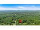 Aerial view of home location in wooded neighborhood with mountain views on the horizon at 323 Bells Ferry Ne Rd, White, GA 30184