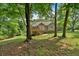 Exterior view of home from back yard with mature trees and view of back deck at 323 Bells Ferry Ne Rd, White, GA 30184